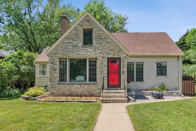 5640 13th Ave S, Minneapolis, MN 55417 - view of front of house featuring stone siding, a chimney, roof with shingles, a patio, and entry steps
