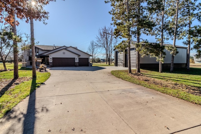2053 45th St SE, Saint Cloud, MN 56304 - view of front of house featuring concrete driveway, a front yard, and a garage