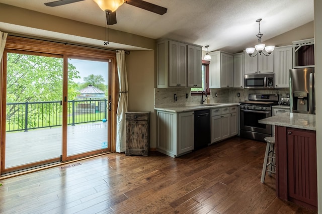 2053 45th St SE, Saint Cloud, MN 56304 - kitchen with stainless steel appliances, a sink, backsplash, a chandelier, and dark wood-style floors