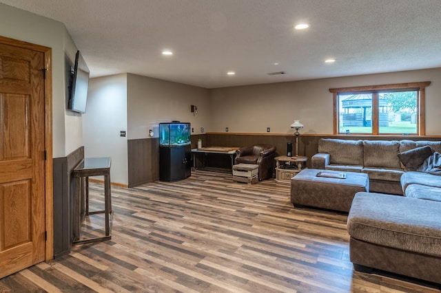 2053 45th St SE, Saint Cloud, MN 56304 - living room with wood finished floors, recessed lighting, wainscoting, and a textured ceiling