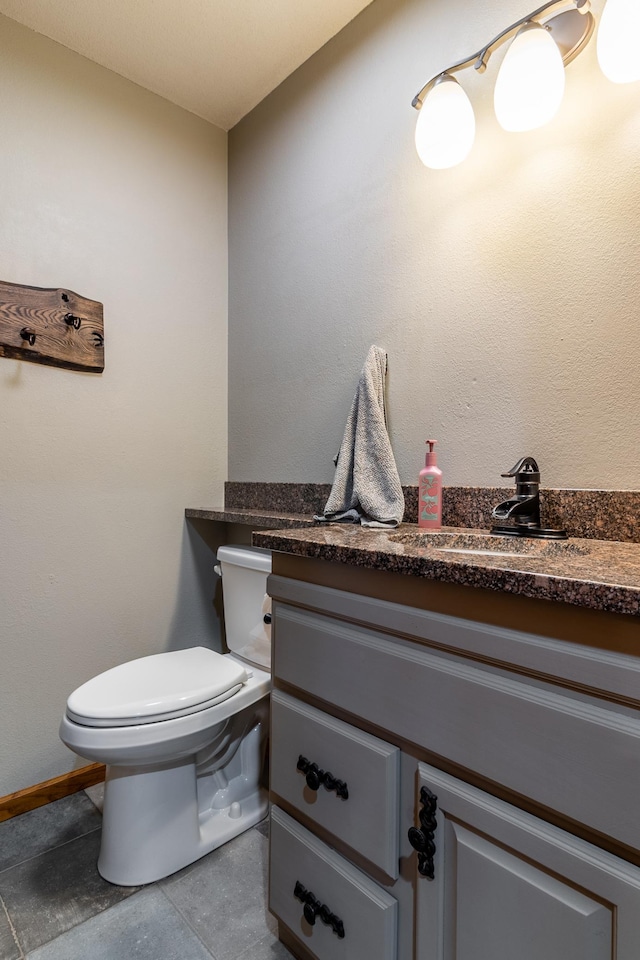 2053 45th St SE, Saint Cloud, MN 56304 - half bathroom featuring vanity, toilet, baseboards, and tile patterned floors