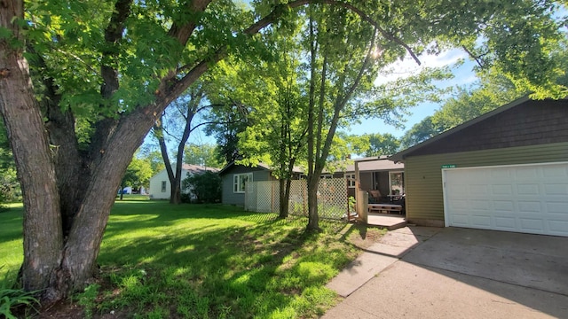732 Vernon Ave NW, Elk River, MN 55330 - view of green lawn featuring a garage and concrete driveway