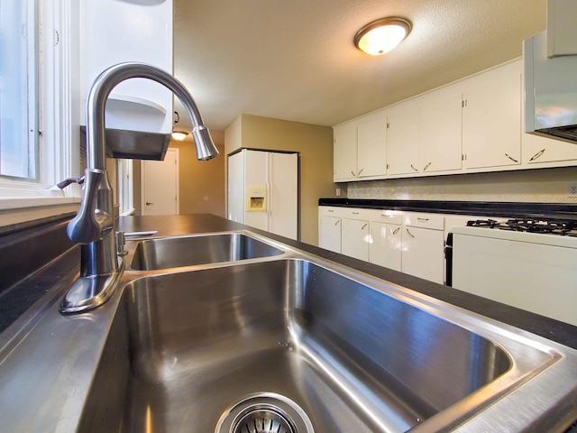 732 Vernon Ave NW, Elk River, MN 55330 - kitchen view of white cabinets, dark countertops, and backsplash