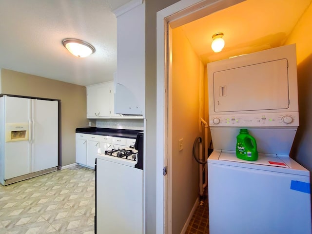 732 Vernon Ave NW, Elk River, MN 55330 - washroom featuring stacked washer and clothes dryer, light floors, and baseboards
