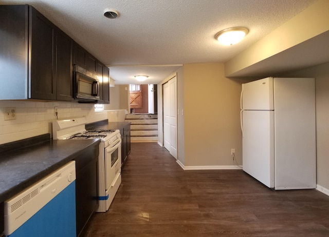 732 Vernon Ave NW, Elk River, MN 55330 - kitchen featuring white appliances, dark countertops, a textured ceiling, dark wood-style flooring, and backsplash