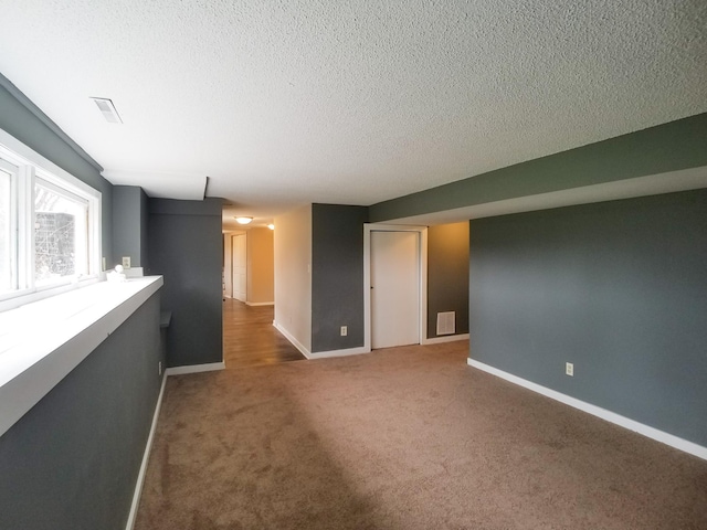 732 Vernon Ave NW, Elk River, MN 55330 - empty room featuring baseboards, carpet, and a textured ceiling