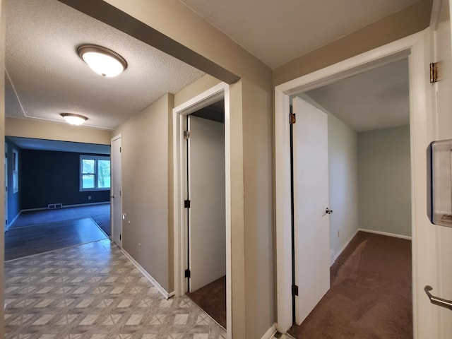 732 Vernon Ave NW, Elk River, MN 55330 - corridor with baseboards and a textured ceiling