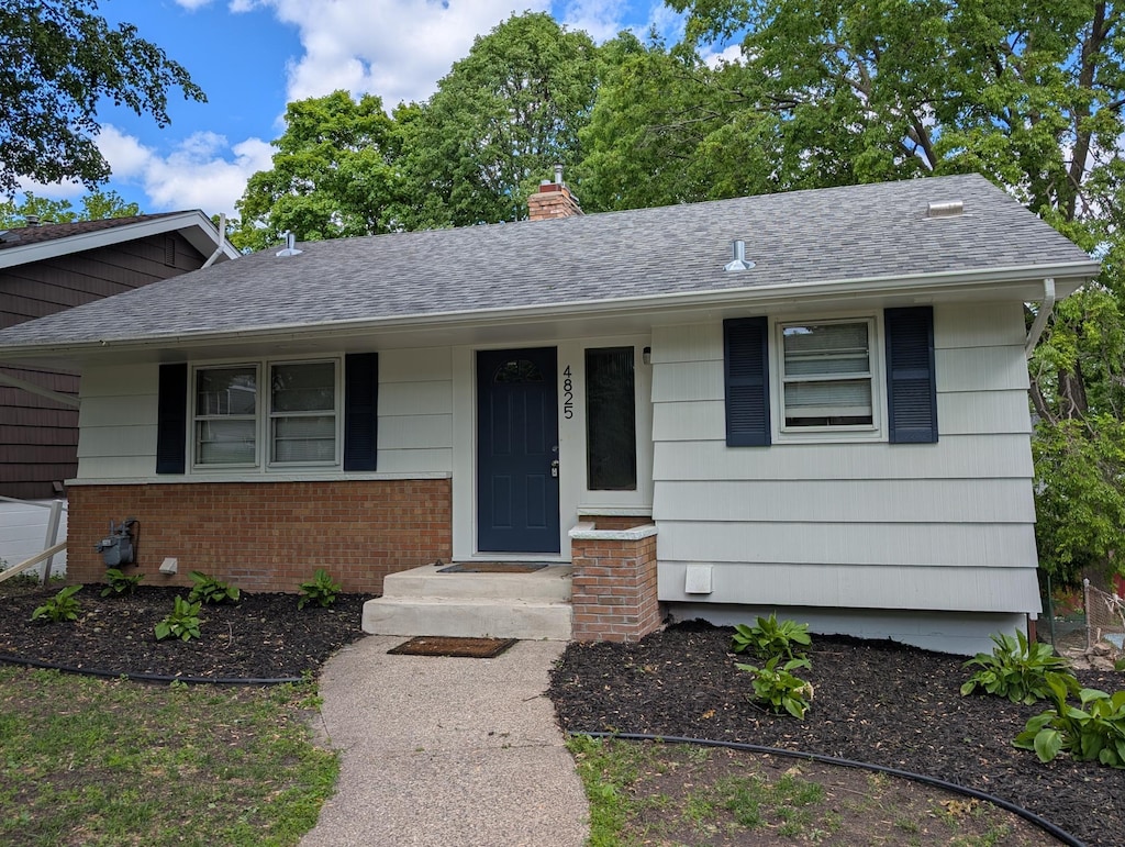 4825 Drew Ave S, Minneapolis, MN 55410 - ranch-style house with a chimney, a shingled roof, and brick siding