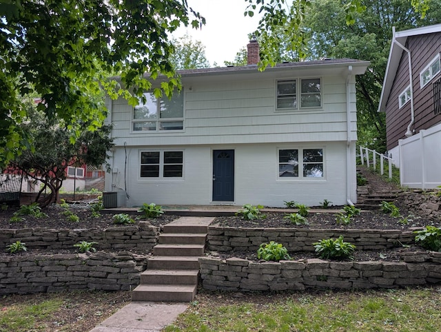 4825 Drew Ave S, Minneapolis, MN 55410 - colonial-style house with a chimney, stairway, and central AC unit