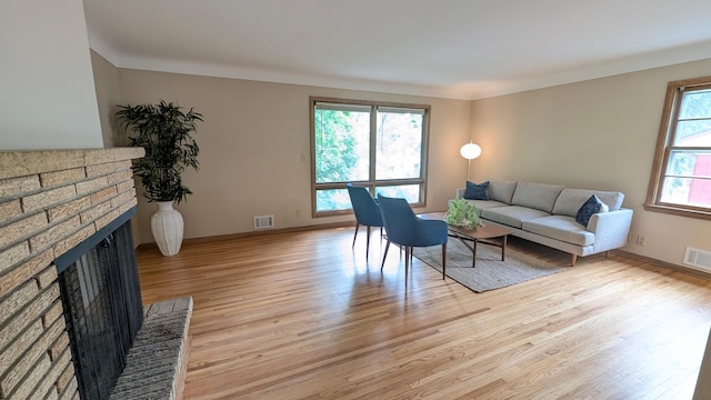 4825 Drew Ave S, Minneapolis, MN 55410 - living area with light wood-type flooring, a brick fireplace, and baseboards