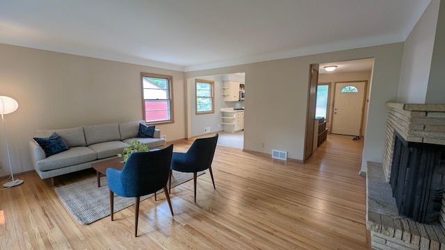 4825 Drew Ave S, Minneapolis, MN 55410 - living room with light wood-style floors, baseboards, and a fireplace
