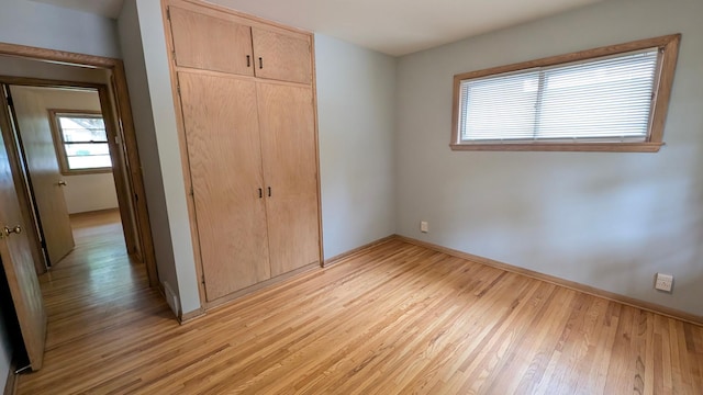 4825 Drew Ave S, Minneapolis, MN 55410 - unfurnished bedroom featuring a closet, light wood-style floors, and baseboards