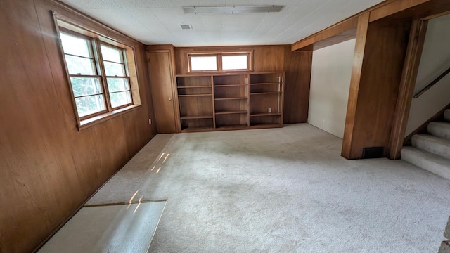 4825 Drew Ave S, Minneapolis, MN 55410 - basement featuring wooden walls, plenty of natural light, stairs, and carpet floors