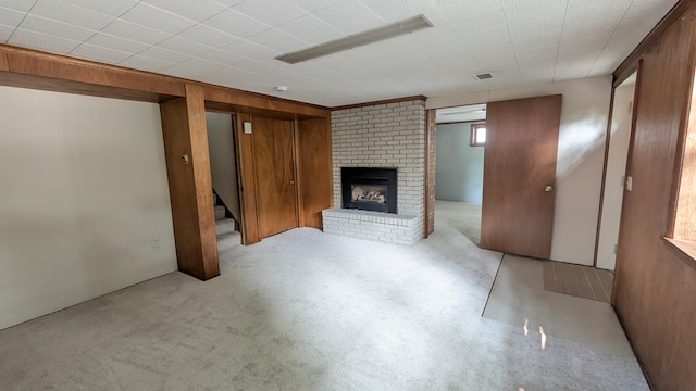 4825 Drew Ave S, Minneapolis, MN 55410 - below grade area with a brick fireplace, stairs, wood walls, and carpet flooring