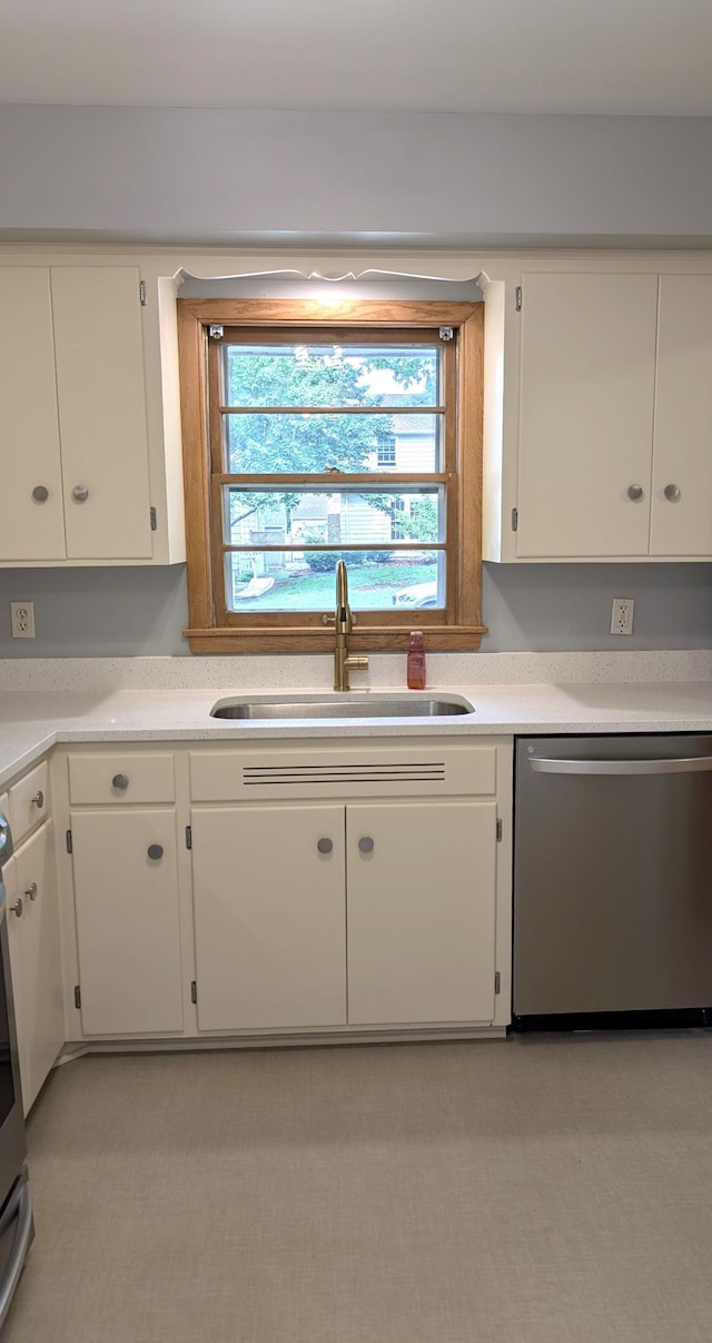 4825 Drew Ave S, Minneapolis, MN 55410 - kitchen featuring stainless steel dishwasher, a sink, white cabinetry, light countertops, and stove