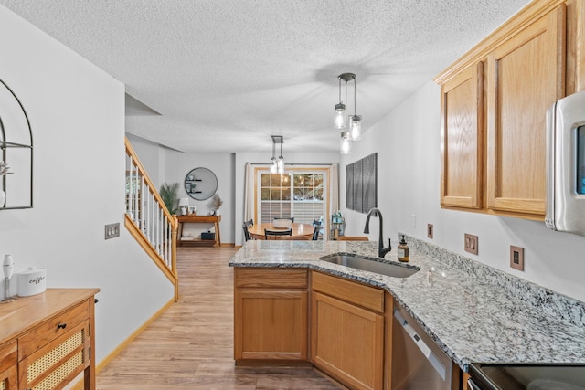 1297 124th Ave NE, Blaine, MN 55434 - kitchen with dishwasher, a peninsula, light wood finished floors, a textured ceiling, and light stone countertops