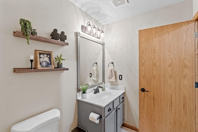 1297 124th Ave NE, Blaine, MN 55434 - bathroom featuring vanity and a textured ceiling