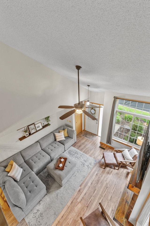 1297 124th Ave NE, Blaine, MN 55434 - living area featuring a ceiling fan, a textured ceiling, and wood finished floors