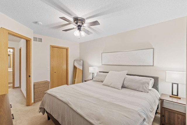 1297 124th Ave NE, Blaine, MN 55434 - bedroom with light colored carpet, a ceiling fan, a textured ceiling, and a closet