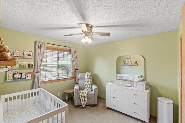 1297 124th Ave NE, Blaine, MN 55434 - bedroom with a nursery area, light carpet, a textured ceiling, and ceiling fan