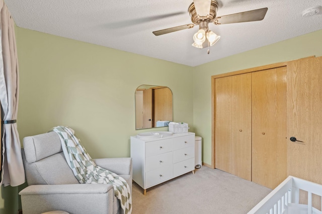 1297 124th Ave NE, Blaine, MN 55434 - bedroom featuring light colored carpet, a closet, ceiling fan, and a textured ceiling