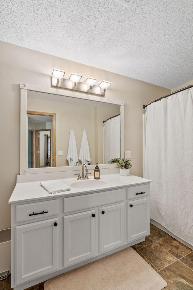 1297 124th Ave NE, Blaine, MN 55434 - full bathroom with vanity, a textured ceiling, stone finish flooring, and a shower with curtain