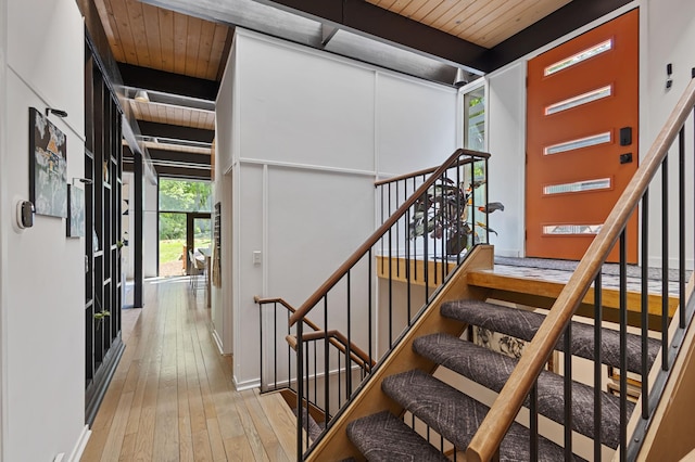 18101 Woolman Dr, Minnetonka, MN 55345 - stairs featuring wood-type flooring, wooden ceiling with exposed beams, and baseboards