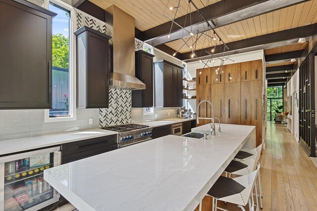 18101 Woolman Dr, Minnetonka, MN 55345 - kitchen with beverage cooler, wall chimney range hood, decorative backsplash, wood ceiling with exposed beams, and a sink