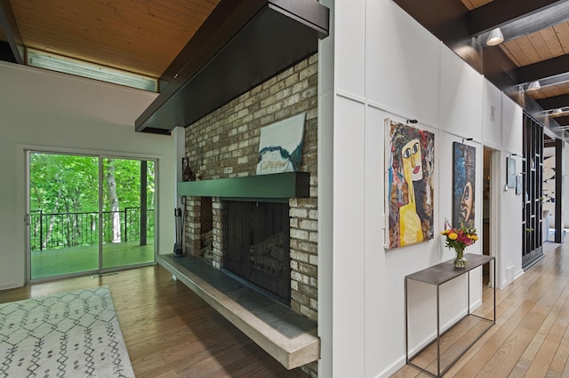 18101 Woolman Dr, Minnetonka, MN 55345 - living area with wooden ceiling with exposed beams, hardwood / wood-style floors, and a brick fireplace