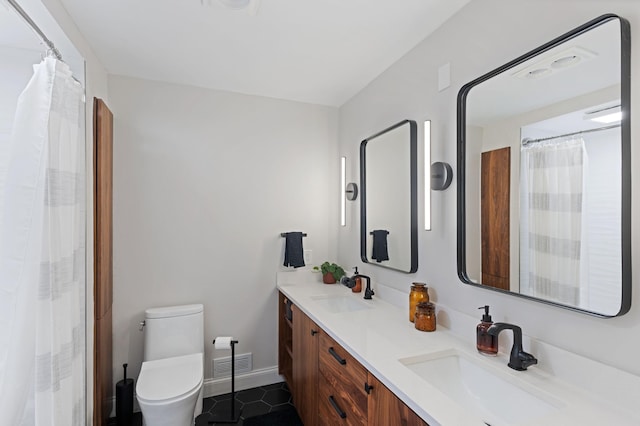 18101 Woolman Dr, Minnetonka, MN 55345 - bathroom featuring double vanity, tile patterned flooring, toilet, baseboards, and a shower with curtain