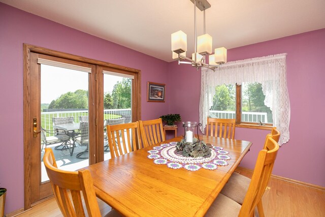 176 Westchester Dr NW, Rochester, MN 55901 - dining area featuring a chandelier and light wood-type flooring
