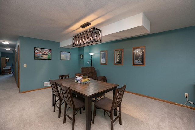 176 Westchester Dr NW, Rochester, MN 55901 - dining room with light carpet, baseboards, and a textured ceiling