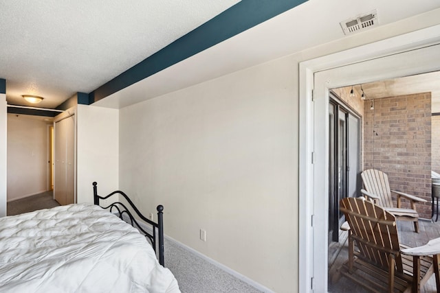 20 2nd St NE Unit P1008, Minneapolis, MN 55413 - bedroom featuring carpet, baseboards, and a textured ceiling