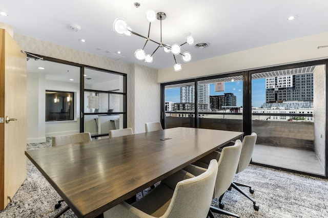 20 2nd St NE Unit P1008, Minneapolis, MN 55413 - dining area featuring wallpapered walls, a chandelier, a city view, and recessed lighting