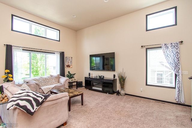 4110 Clubhouse Dr S, Fargo, ND 58104 - carpeted living room featuring a high ceiling and baseboards