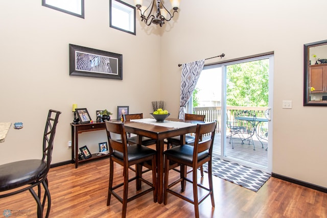 4110 Clubhouse Dr S, Fargo, ND 58104 - dining room featuring a chandelier, light wood-style floors, plenty of natural light, and a high ceiling