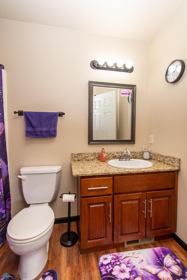4110 Clubhouse Dr S, Fargo, ND 58104 - full bath featuring wood finished floors, vanity, toilet, and baseboards