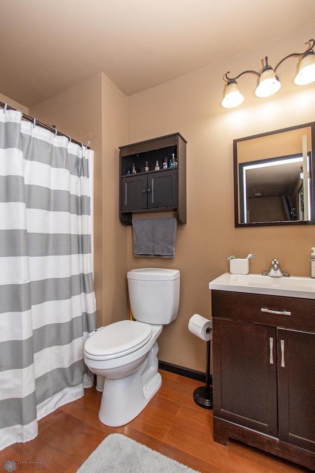 4110 Clubhouse Dr S, Fargo, ND 58104 - bathroom featuring toilet, wood finished floors, vanity, and curtained shower