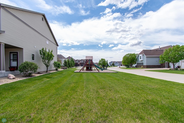 4110 Clubhouse Dr S, Fargo, ND 58104 - view of grassy yard with a playground and a residential view