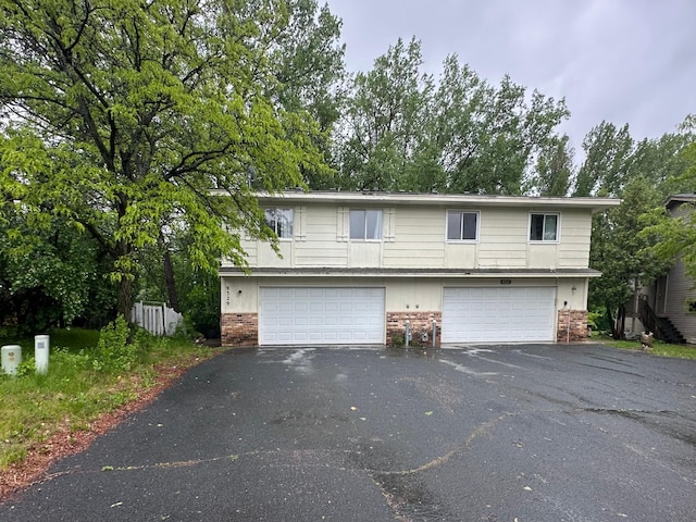 9329 Bass Creek Cir N, New Hope, MN 55428 - view of front of home featuring brick siding, driveway, and an attached garage
