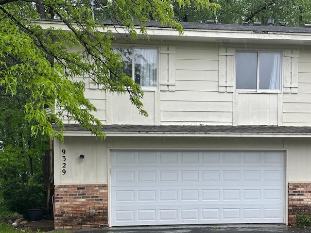 9329 Bass Creek Cir N, New Hope, MN 55428 - view of side of home with brick siding and an attached garage