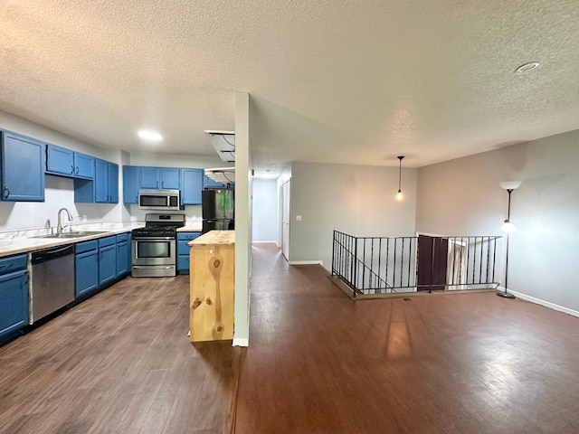 9329 Bass Creek Cir N, New Hope, MN 55428 - kitchen featuring appliances with stainless steel finishes, blue cabinetry, a sink, dark wood-style flooring, and a textured ceiling