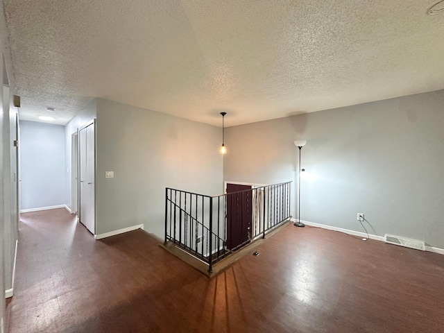 9329 Bass Creek Cir N, New Hope, MN 55428 - corridor with an upstairs landing, a textured ceiling, wood finished floors, and baseboards