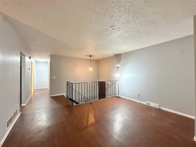 9329 Bass Creek Cir N, New Hope, MN 55428 - empty room with a textured ceiling, dark wood-type flooring, and baseboards