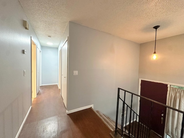 9329 Bass Creek Cir N, New Hope, MN 55428 - hall with an upstairs landing, a textured ceiling, wood finished floors, and baseboards