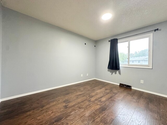 9329 Bass Creek Cir N, New Hope, MN 55428 - empty room featuring dark wood-style floors and baseboards