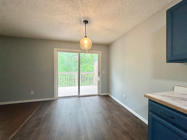 9329 Bass Creek Cir N, New Hope, MN 55428 - unfurnished dining area featuring dark wood-style floors, baseboards, and a textured ceiling
