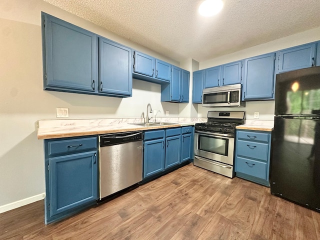 9329 Bass Creek Cir N, New Hope, MN 55428 - kitchen featuring appliances with stainless steel finishes, blue cabinets, and a textured ceiling