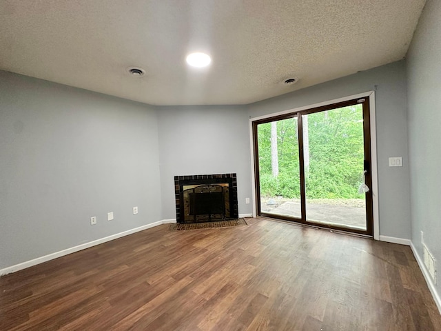 9329 Bass Creek Cir N, New Hope, MN 55428 - unfurnished living room with dark wood-style flooring, baseboards, a fireplace, and a textured ceiling