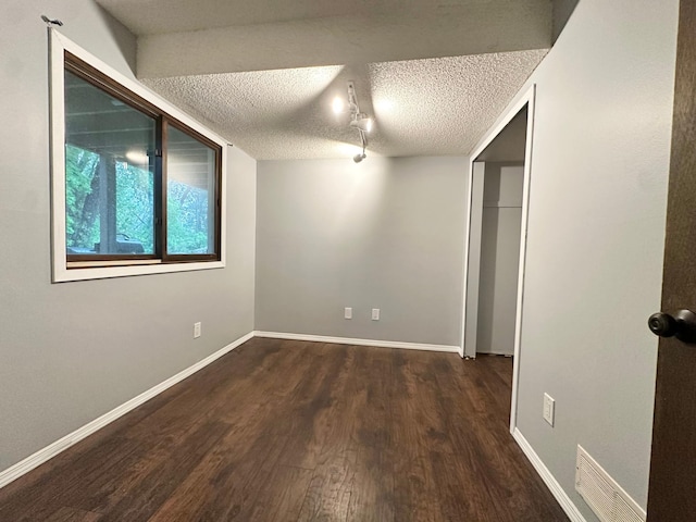 9329 Bass Creek Cir N, New Hope, MN 55428 - empty room featuring wood finished floors, a textured ceiling, and baseboards